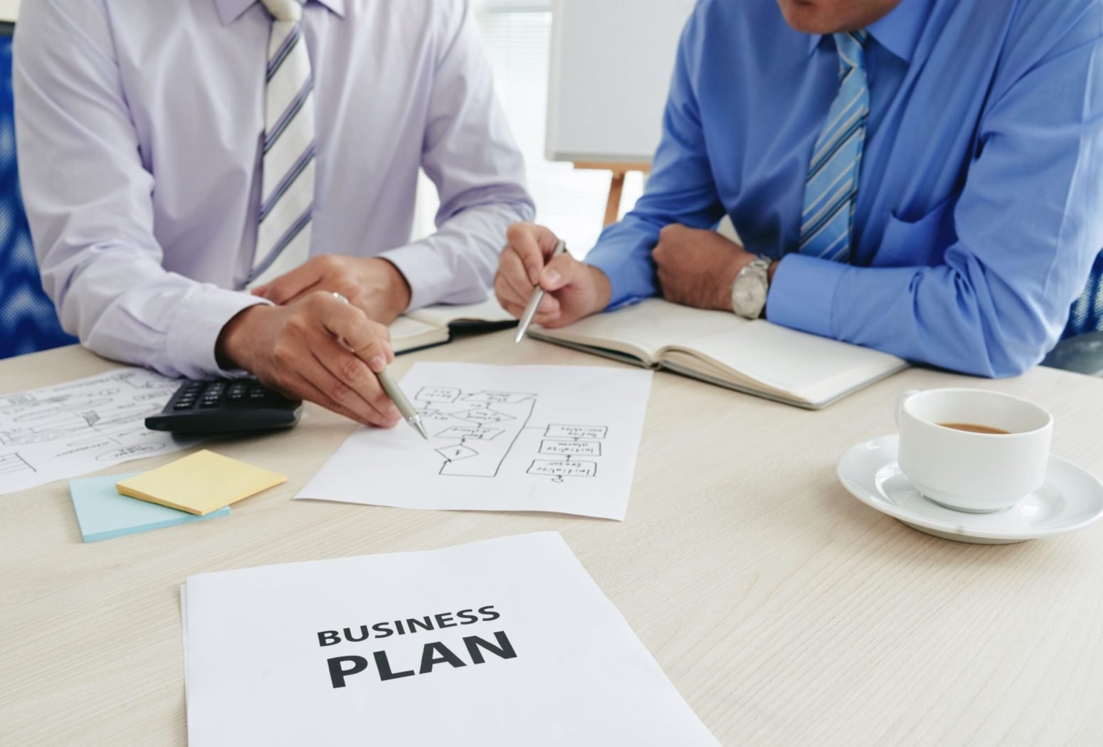 two-cropped-startuppers-developing-business-plan-min